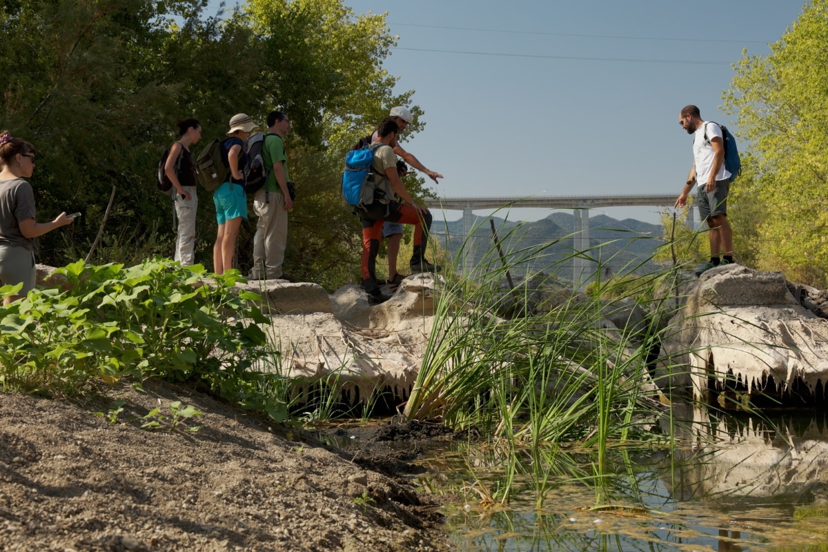 People from Collettivo Rewild Sicily looking at a river