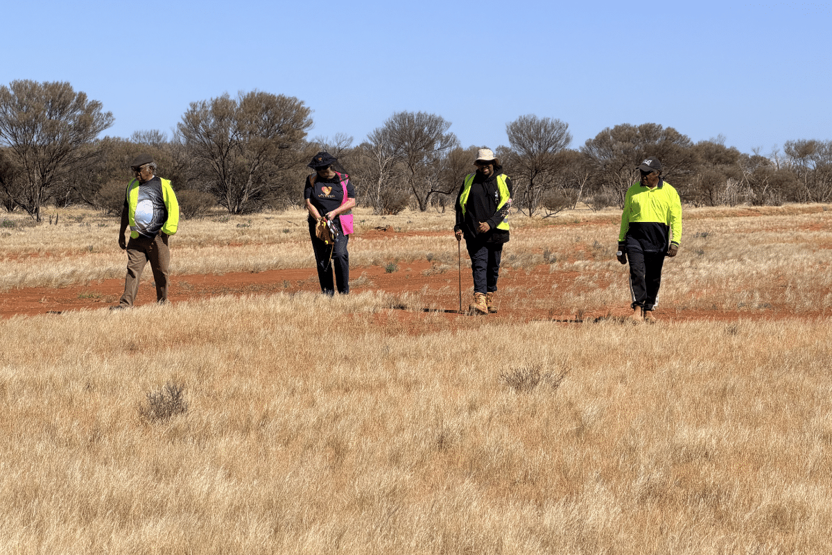 Donalea walking the Camel Graveyard trial site with Elder Preston Thomas, his son Matt and grandson Jeremiah.