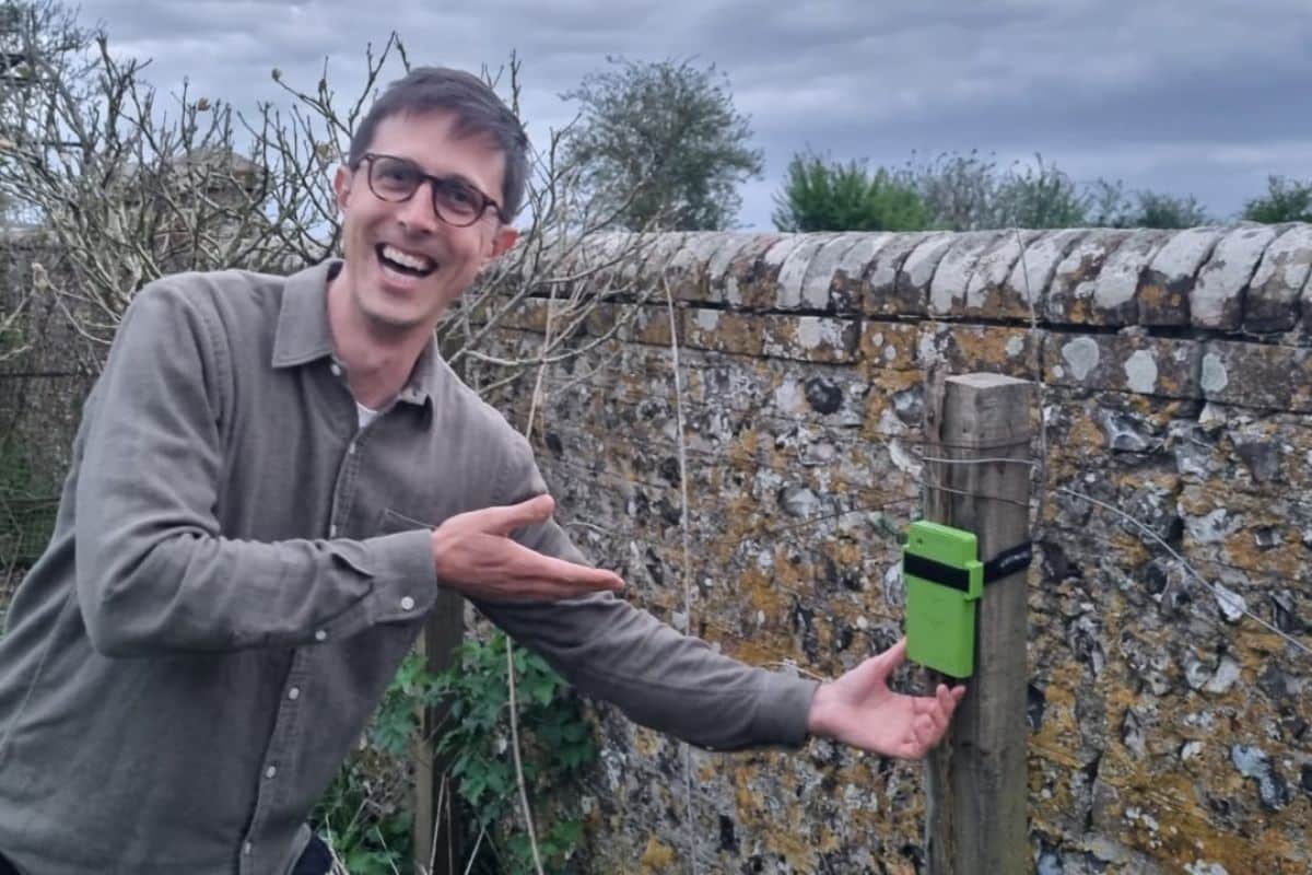 Man smiling showing bioacoustic monitor